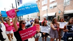 FILE - Opponents and supporters of Planned Parenthood demonstrate in Philadelphia, July 28, 2015.