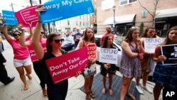 FILE - Opponents and supporters of Planned Parenthood demonstrate in Philadelphia, July 28, 2015.