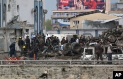 Afghan security forces inspect the site of a Taliban-claimed deadly suicide attack in Kabul, Afghanistan, April 19, 2016.