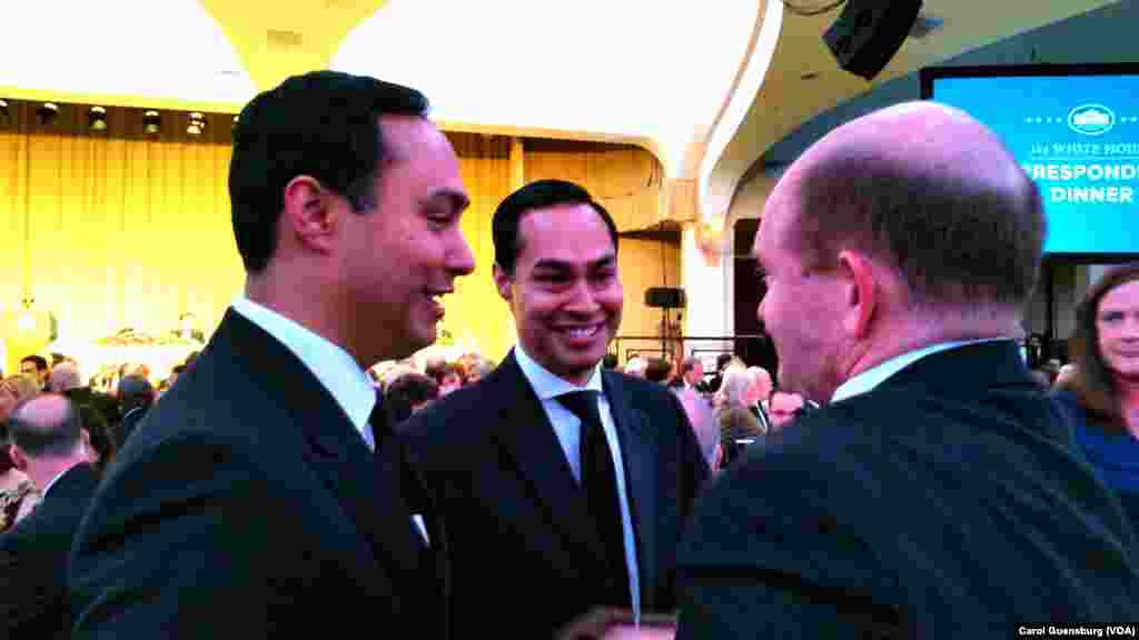 Congressman Joaquin Castro of Texas, left, and his identical twin, Secretary of Housing Julian Castro, chat with Sen. Chris Coons of Delaware at the White House Correspondents Association dinner in Washington, April 30, 2016. All three are Democrats. 