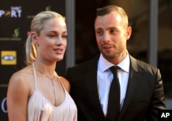 FILE - South African Olympic athlete Oscar Pistorius and Reeva Steenkamp at an awards ceremony, in Johannesburg, Nov. 4, 2012.