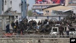 Afghan security forces inspect the site of a Taliban-claimed deadly suicide attack in Kabul, Afghanistan, April 19, 2016. 