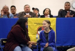 FILE - Climate change environmental activist Greta Thunberg joins Red Cloud Indian School student and activist Tokata Iron Eyes at a youth panel at the Standing Rock Indian Reservation, North Dakota, Oct. 8, 2019.