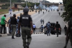 Nigerian police officers patrol in the streets of Abuja during clashes with members of the shiite Islamic Movement of Nigeria on July 22, 2019.