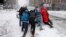 People push a stranded taxi during a snowstorm, Tuesday, March 13, 2018, in Boston. The third major nor’easter in two weeks slammed New England on Tuesday, bringing blizzard conditions and more than a foot of snow to some communities.