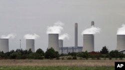 FILE—The cooling towers at Eskom's coal-powered Lethabo power station are seen near Sasolburg, South Africa, on November 21, 2011. 