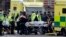 Emergency services transport an injured person to an ambulance, close to the Houses of Parliament in London, March 22, 2017.