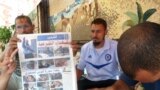Muslim Brotherhood doctors hold up newspaper with photos of their supporters killed in a confrontation with the Egyptian military on July 8. Photo: VOA/Sharon Behn&nbsp;