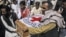 Pakistani hospital staff and rescue workers carry the coffin of British Red Cross worker Khalil Rasjed Dale to an ambulance, from a hospital in Quetta, Pakistan, April 30, 2012.