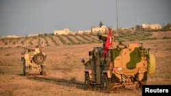 Turkish and U.S. troops are pictured during a joint patrol in Manbij area, northern Syria, Nov. 8, 2018. (Turkish Defense Ministry/Turkish Military/Handout via Reuters)