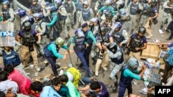 Police personnel baton-charge protesting supporters of Chinmoy Krishna Das Brahmachari, a jailed Hindu monk leader, during a demonstration after court denied his bail in Chittagong on Nov. 26, 2024.