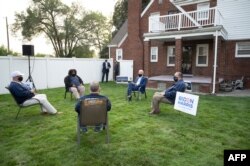 FILE - Democratic presidential candidate former Vice President Joe Biden (C) speaks with steelworkers during a backyard conversation in Detroit, Michigan, Sept. 9, 2020. On Oct. 16, 2020, Biden is due in Southfield and Detroit, Michigan.