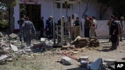 Egyptian security officials investigate a checkpoint attacked by gunmen in Shubra al-Kheima, a suburb north of Cairo, March 15, 2014.