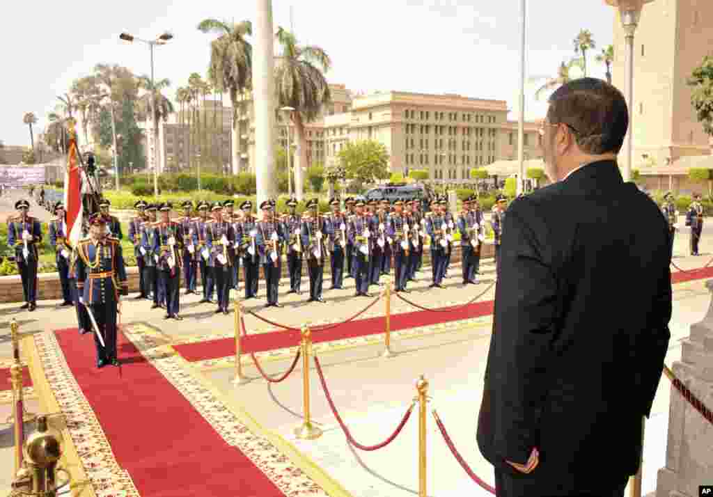 Egyptian President Mohammed Morsi stands before a military honor guard after his inauguration in Cairo, Egypt, June 30, 2012.