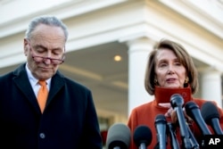 FILE - House Minority Leader Nancy Pelosi of Calif., right, accompanied by Senate Minority Leader Sen. Chuck Schumer of N.Y., left, speaks to members of the media outside the West Wing of the White House in Washington, Dec. 11, 2018.