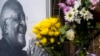 Flowers are placed alongside a photo of Anglican Archbishop Desmond Tutu at the St. George's Cathedral in Cape Town, South Africa, Dec. 26, 2021. 