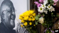 Flowers are placed alongside a photo of Anglican Archbishop Desmond Tutu at the St. George's Cathedral in Cape Town, South Africa, Dec. 26, 2021. 