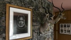 A portrait of Ernest Hemingway hangs above the fireplace next to game trophies in the house once owned by the novelist in Ketchum, Idaho