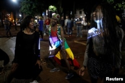 Gaby (left), 18, Vitor (center), 21, and Pamela, who are among members of lesbian, gay, bisexual and transgender (LGBT) community, dance during an event of Arouchianos collective project at Arouche Square in downtown Sao Paulo, Brazil, Nov. 6, 2016.