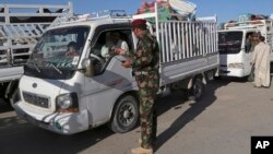 Iraqi security forces check identification documents at a checkpoint near the entrance to Ramadi, 70 miles (115 kilometers) west of Baghdad, Iraq, April 3, 2016. 