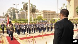 Egyptian President Mohammed Morsi stands before a military honor guard after his inauguration in Cairo, Egypt, June 30, 2012.