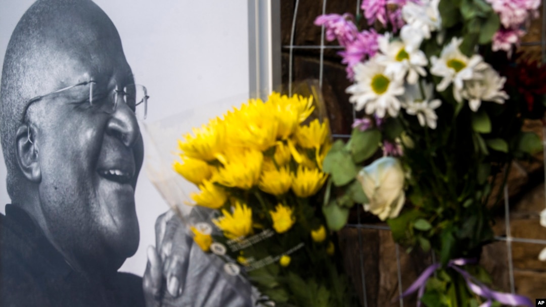 Flowers are placed alongside a photo of Anglican Archbishop Desmond Tutu at the St. George's Cathedral in Cape Town, South Africa, Dec. 26, 2021. 