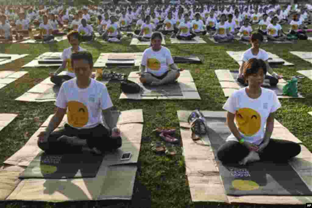 Malaysians participate in a yoga exercise during the International Day of Yoga festival in Kuala Lumpur, Malaysia on Sunday, June 21, 2015. Indian Prime Minister Narendra Modi called for the adoption of June 21 as the official date for the International D