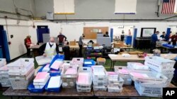 Chester County election workers scan mail-in and absentee ballots for the 2020 U.S. general election, at West Chester University, in West Chester, Pennsylvania, Nov. 4, 2020. 