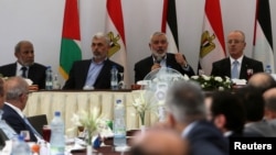 Hamas Chief Ismail Haniyeh speaks as he sits next to Palestinian Prime Minister Rami Hamdallah during the meeting in Gaza City, Oct. 3, 2017. 