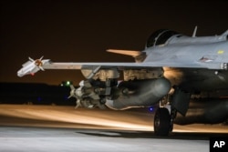 This photo released on Tuesday, Nov. 17, 2015 by the French Army Communications Audiovisual office (ECPAD) shows a French army Rafale jet on the tarmac of an undisclosed air base as part of France's Operation Chammal.