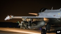 FILE - This photo released on Tuesday, Nov. 17, 2015 by the French Army Communications Audiovisual office (ECPAD) shows a French Rafale jet on the tarmac of an undisclosed air base as part of France's Operation Chammal launched in Sept. 2015 in support of the US-led coalition against the Islamic State group.