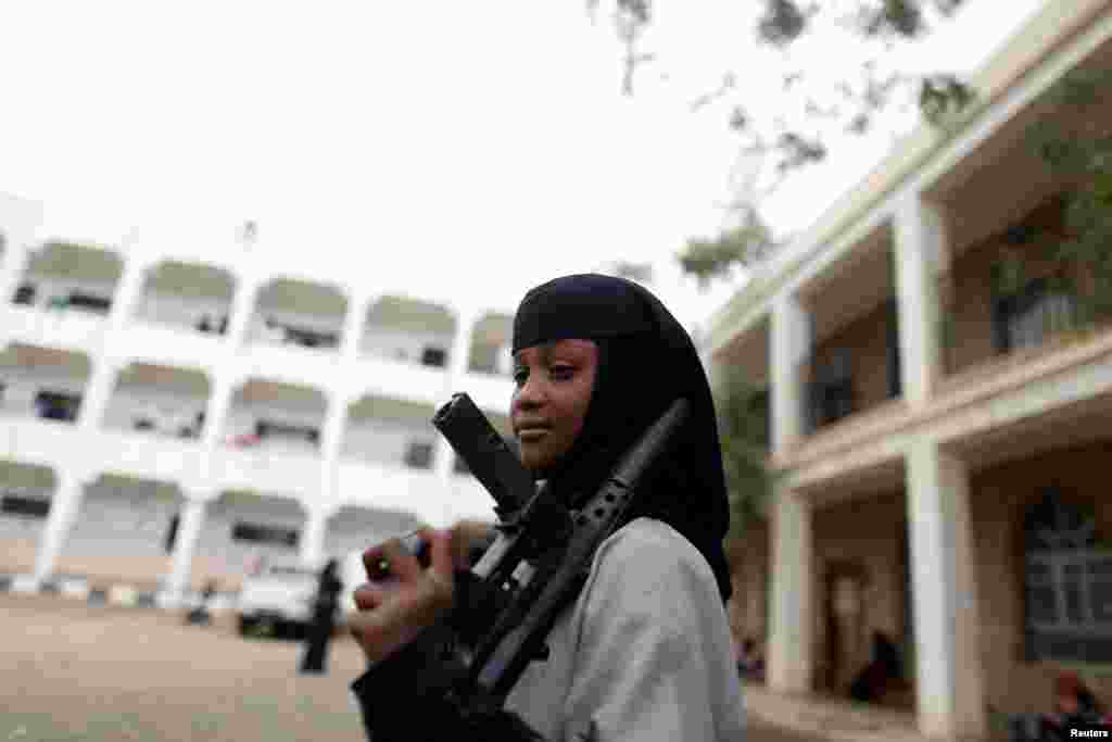 A girl displaced by the fighting in the Red Sea port city of Hodeidah holds a toy rifle at a school where IDPs live in Sana&#39;a, Yemen, June 26, 2018.