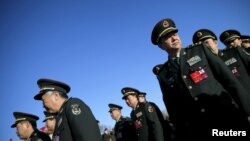 Military delegates arrive at the Great Hall of the People for the third plenary session of the National People's Congress (NPC), in Beijing, China, March 13, 2016.