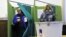 A Slovenian couple votes during the second round of presidential elections at a polling station in Planina, December 2, 2012.