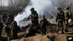 Indian army soldiers arrive near the wreckage of an Indian aircraft after it crashed in Budgam area, outskirts of Srinagar, Indian controlled Kashmir, Wednesday, Feb.27, 2019. (AP Photo/Mukhtar Khan)