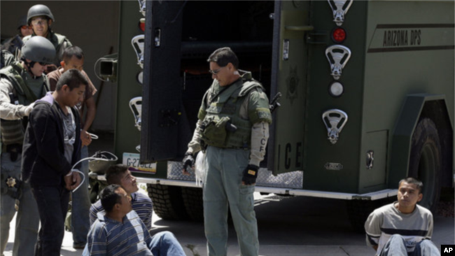 Foto Archivo - Sospechosos de inmigrantes indocumentados son detenidos por agentes de la ley en Phoenix después de allanar una casa jueves, 29 de abril de 2010.