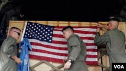 US soldiers from Marine Aircraft Group 36 adjust flags on a cargo of aid after loading it onto a cargo plane. (File)