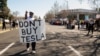 People protest against Tesla and Elon Musk outside of a Tesla dealership in Palo Alto, California, on March 8, 2025. U.S. President Donald Trump said on March 11 he would buy a Tesla vehicle as a show of support as the company becomes a focal point of protests against Musk.