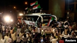 FILE - Sudanese demonstrators from the Darfur region chant slogans as they arrive to be part of a mass anti-government protest outside Defense Ministry in Khartoum, Sudan, Apr. 30, 2019. 