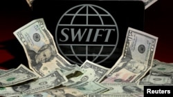 The Swift logo is pictured in this photo illustration taken April 26, 2016 in New York. Belgium-based Swift oversees international financial transfers.