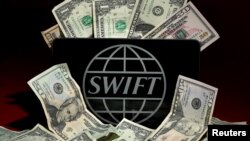 FILE - The SWIFT logo is pictured in this photo illustration taken April 26, 2016 in New York. SWIFT will launch a five-point plan later this week.