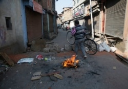 A Kashmiri man crosses a barricade put up by protesters in downtown in Srinagar, Indian controlled Kashmir, Thursday, Oct. 31, 2019. (AP Photo/Mukhtar Khan)