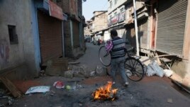 A Kashmiri man crosses a barricade put up by protesters in downtown in Srinagar, Indian controlled Kashmir, Thursday, Oct. 31, 2019. (AP Photo/Mukhtar Khan)