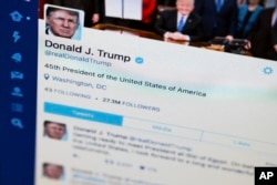 FILE- President Donald Trump's Twitter feed is photographed on a computer screen in Washington. April 3, 2017.