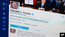 FILE- President Donald Trump's Twitter feed is photographed on a computer screen in Washington. April 3, 2017. 