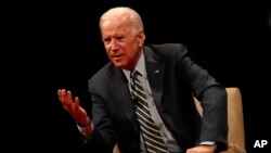 FILE - Former Vice President Joe Biden participates in a discussion on bridging political and partisan divides with Ohio Gov. John Kasich at the University of Delaware, Newark, Del., Oct. 17, 2017.