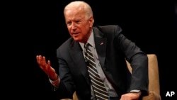 Former Vice President Joe Biden participates in a discussion on bridging political and partisan divides with Ohio Gov. John Kasich at the University of Delaware, Newark, Del., Oct. 17, 2017.