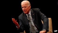 Former Vice President Joe Biden participates in a discussion on bridging political and partisan divides with Ohio Gov. John Kasich at the University of Delaware, Newark, Del., Oct. 17, 2017.