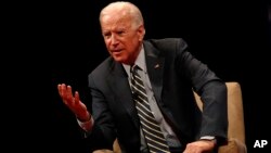 Former Vice President Joe Biden participates in a discussion on bridging political and partisan divides with Ohio Gov. John Kasich at the University of Delaware, Newark, Del., Oct. 17, 2017.