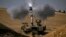 EDITORS NOTE: Graphic content / TOPSHOT - An Israeli army M109 155mm self-propelled howitzer fires rounds toward the Gaza Strip from a position in southern Israel across the border on October 28, 2023.